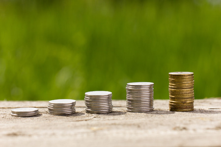 coins on wooden background, outdoors