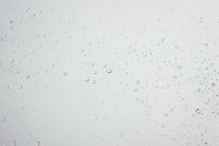 water drops on the glass with a blue tint, the texture of water drops, water backgroundの写真素材