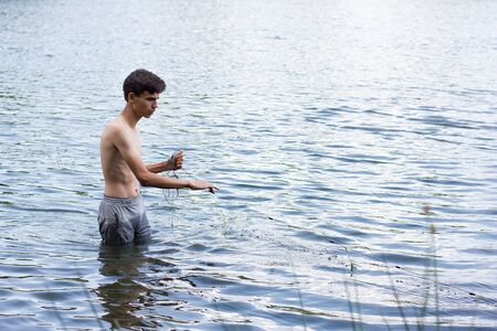 poachers collects nets in the spring season. Poaching on the water. Wildlife Destructionの写真素材