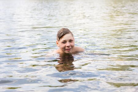 boy bathes in the sea close up, active rest, water proceduresの写真素材