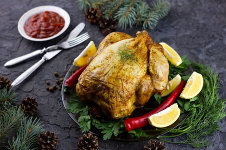 Fried whole chicken on a platter. Holiday lunch, grilled baked chickenの写真素材
