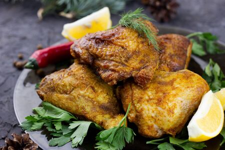 fried chicken thighs for the holiday table. Cooked chicken thighs for new year holidays, homemade foodの写真素材
