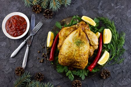 Fried whole chicken on a platter. Holiday lunch, grilled baked chickenの写真素材