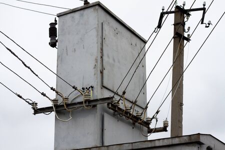 old transformer close-up in the countryside. High-voltage cable disconnector , high voltage