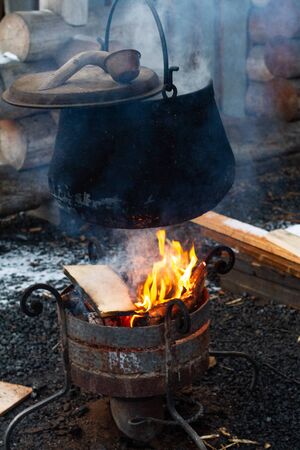 pot on the fire, the concept of wild camping . Cooking in nature during a hike.の写真素材