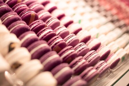 group of multi-colored cakes on shop windows in a kondiri store, close-up. Background of dessert food.の写真素材