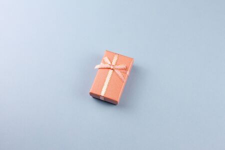 small gift on a pastel background, closeup. Gift box with a bow. copy space.の写真素材