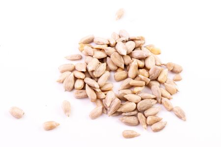 heap of peeled sunflower seeds, closeup, isolated on a white background. Whole sunflower seedの写真素材