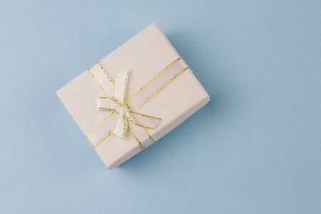 small gift on a pastel background, closeup. Gift box with a bow.の写真素材