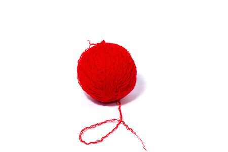 red ball of woolen thread, closeup. Isolated on a white background.の写真素材