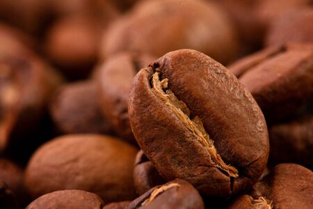 macrophotography of coffee beans, the Texture of coffee beans. Roasted coffee beans on a dark backgroundの写真素材