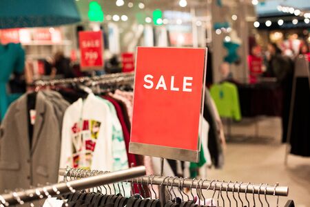 a sign with the inscription sale in a clothing store and a place for an inscription. Boutique...