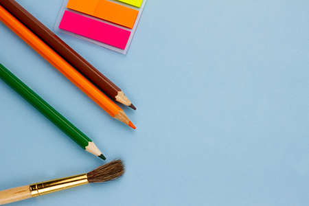 All sorts of bright school supplies on a light blue background. Place for text. Education concept. View from above.の写真素材