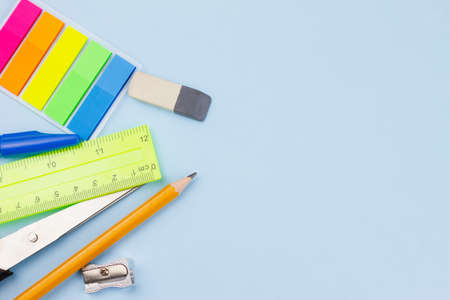 School new supplies on a light blue background. Photo banner. View from above. Place for text.の写真素材