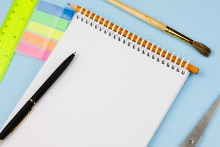 Assorted colorful office supplies on a light blue background. View from above. Education concept.の写真素材