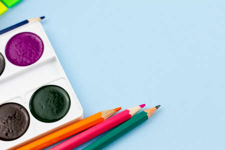 Multicolored bright school drawing set on a light blue background. View from above. Place for text. Education concept.の写真素材