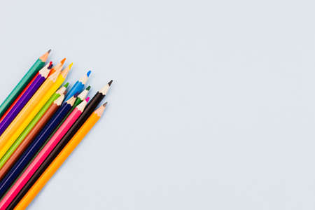 Bright colored assorted pencils on a light blue background. View from above. Place for text.の写真素材