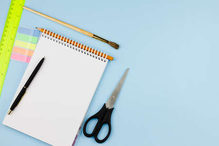 New school supplies on a blue background. Banner photo. View from above. Place for text. Education concept.の写真素材