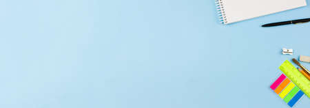 Bright beautiful stationery on a blue background. Photo banner. Place for text. View from above.の写真素材
