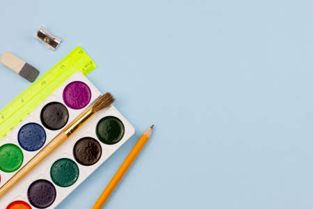 Multicolored bright set for painting on a light blue background. Place for your text. View from above. Education concept.の写真素材