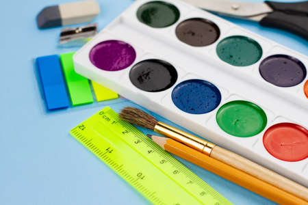 Colorful multi-colored painting supplies on a blue background. View from above. Education concept.の写真素材
