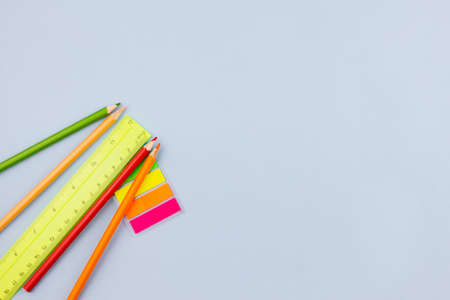 Bright colorful school supplies on a light blue background. Place for text. View from above. Education concept.の写真素材