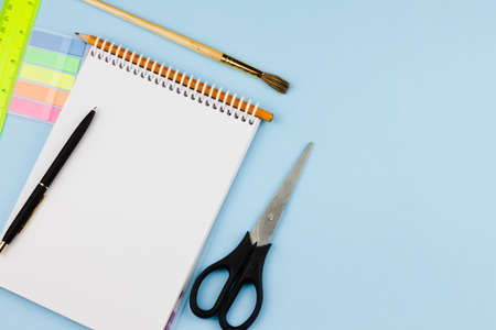 New school supplies on a blue background. Banner photo. View from above. Place for text. Education concept.の写真素材