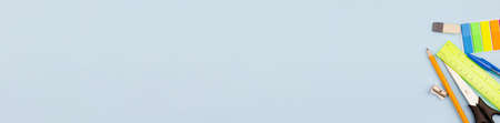 Bright school supplies on a light blue background. Photo banner. View from above. Place for your text.の写真素材