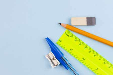 Essential school stationery on a light blue background. View from above. Place for text.の写真素材