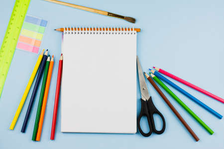 Assorted colorful office supplies on a light blue background. View from above. Education concept.の写真素材