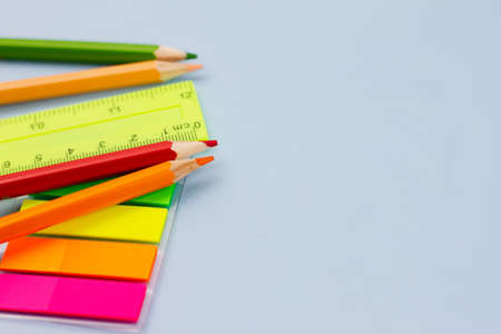 Bright colored stationery for school on a blue background. View from above. Place for text. Education concept.の写真素材