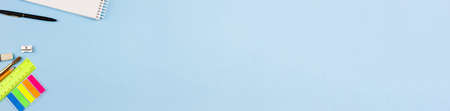 Bright beautiful stationery on a blue background. Photo banner. Place for text. View from above.の写真素材