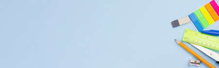 Catchy bright office supplies on a gray background. Photo banner. View from above. Place for text.の写真素材