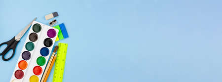 Various school supplies for education on a blue background. Photo banner. View from above. Education concept.の写真素材
