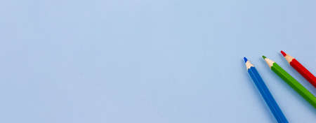 Three colored pencils on a blue background. Photo banner. Place for your text. View from above. Education concept.の写真素材