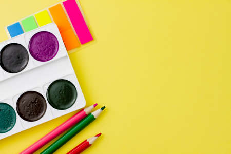 Colorful various office supplies on a yellow background. Place for your text. View from above. Education concept.の写真素材