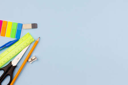 School new supplies on a light blue background. Photo banner. View from above. Place for text.の写真素材