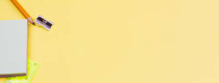 Blank notes with a pencil on a yellow background. Photo banner. View from above. Place for your text.の写真素材