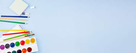 A lot of school supplies on a blue background. Photo banner. Place for your text. Education concept.の写真素材