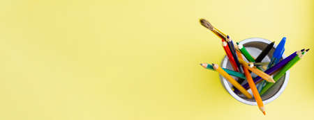 Stand with colored pencils on a yellow background. Photo banner. Education concept. Place for your text.の写真素材