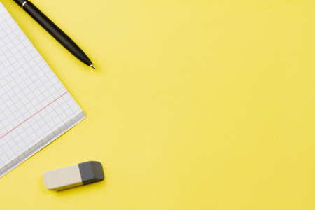 Blank notebook with a black pen on a yellow background. Photo banner. Place for your text. Education concept.の写真素材