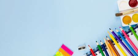 Multicolored bright set for drawing on a blue background. Photo banner. View from above. Place for your text.の写真素材