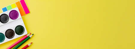 Colorful various office supplies on a yellow background. Banner photo. Place for your text. View from above. Education concept.の写真素材