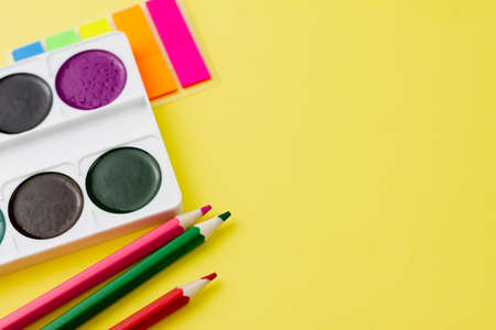 Colorful various office supplies on a yellow background. Place for your text. View from above. Education concept.の写真素材