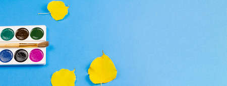 Watercolor paints on an autumn blue background. Photo banner. Place for your text. Photo concept. View from above.の写真素材