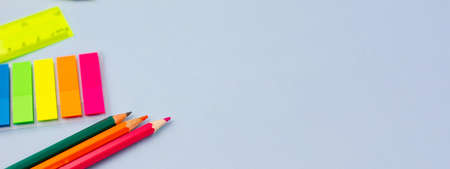 Colored pencils and notes on a blue background. Photo banner. Place for your text. Education concept.の写真素材