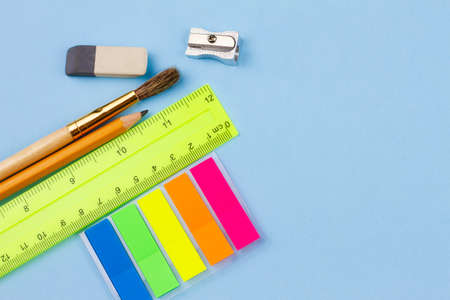 Bright various school supplies on a blue background. View from above. Place for your text. Education concept.の写真素材