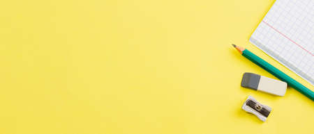 Blank notebook with a pencil on a yellow background. Photo banner. Place for your text. View from above. Education concept.の写真素材