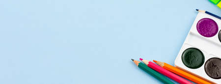Watercolor with colored pencils on a blue background. Photo banner. Place for your text. Education concept.の写真素材