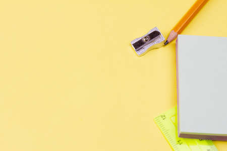 Blank notes with a pencil on a yellow background. Photo banner. View from above. Place for your text.の写真素材